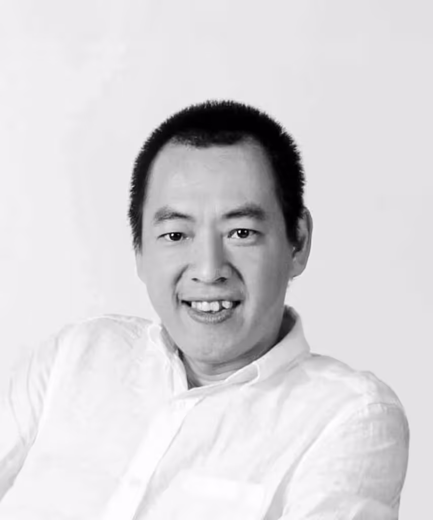 Profile portrait of a man in a white shirt against a light background